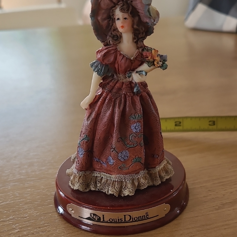 Louis Dionne Porcelain Figurine with Red Base
